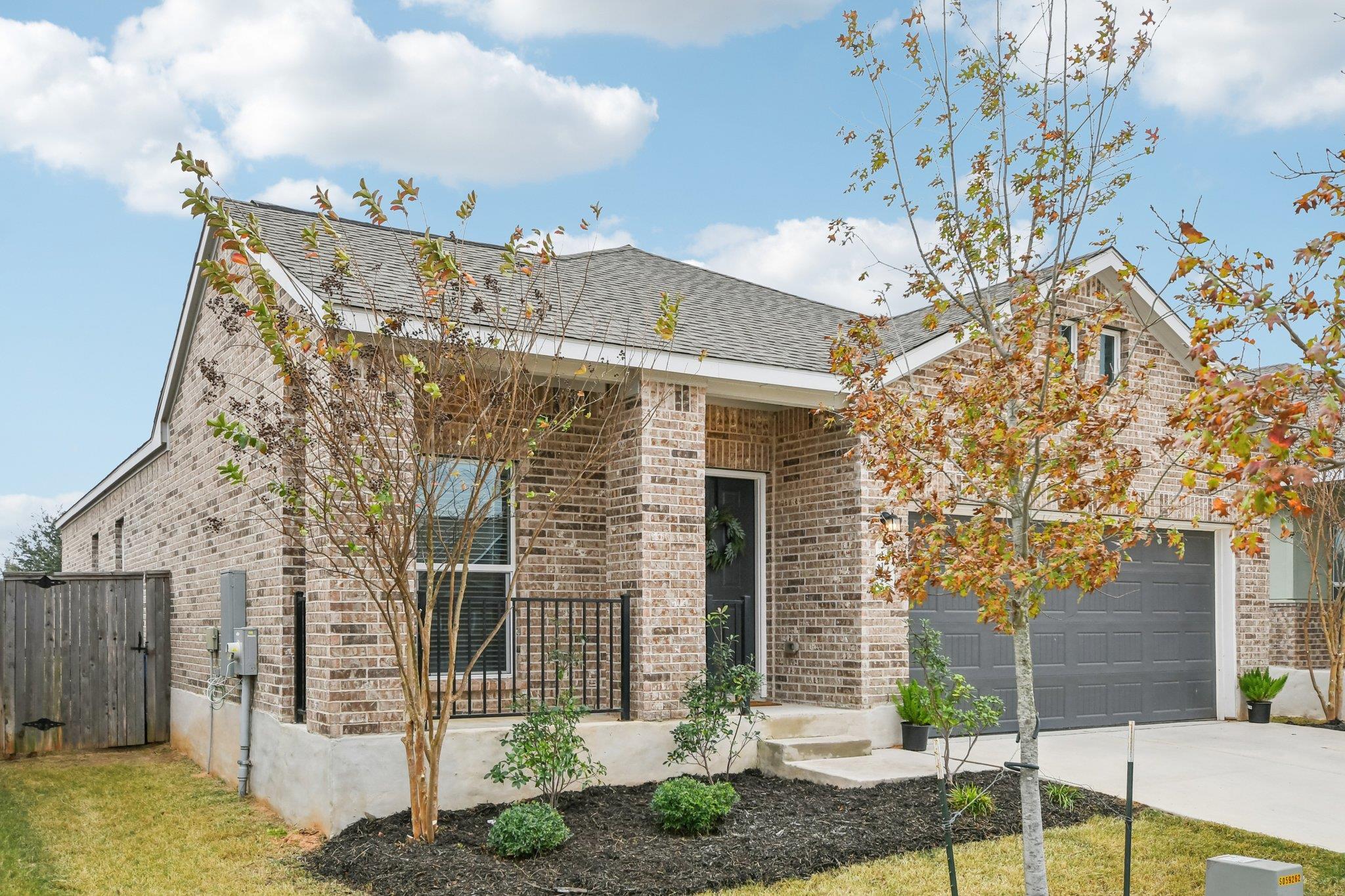 View of front of home featuring brick siding, a g