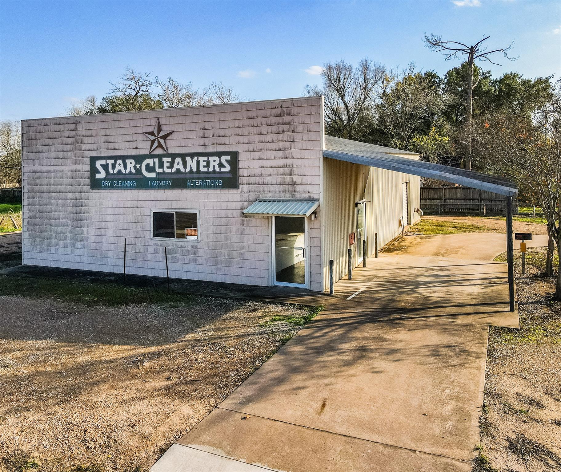 View of building exterior featuring driveway