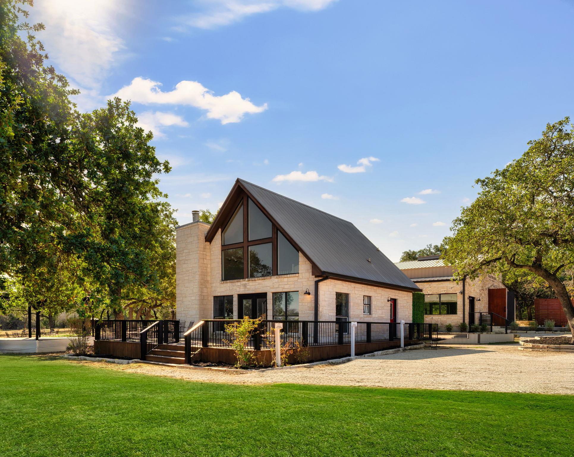 Rear view of property with a lawn, a wooden deck,