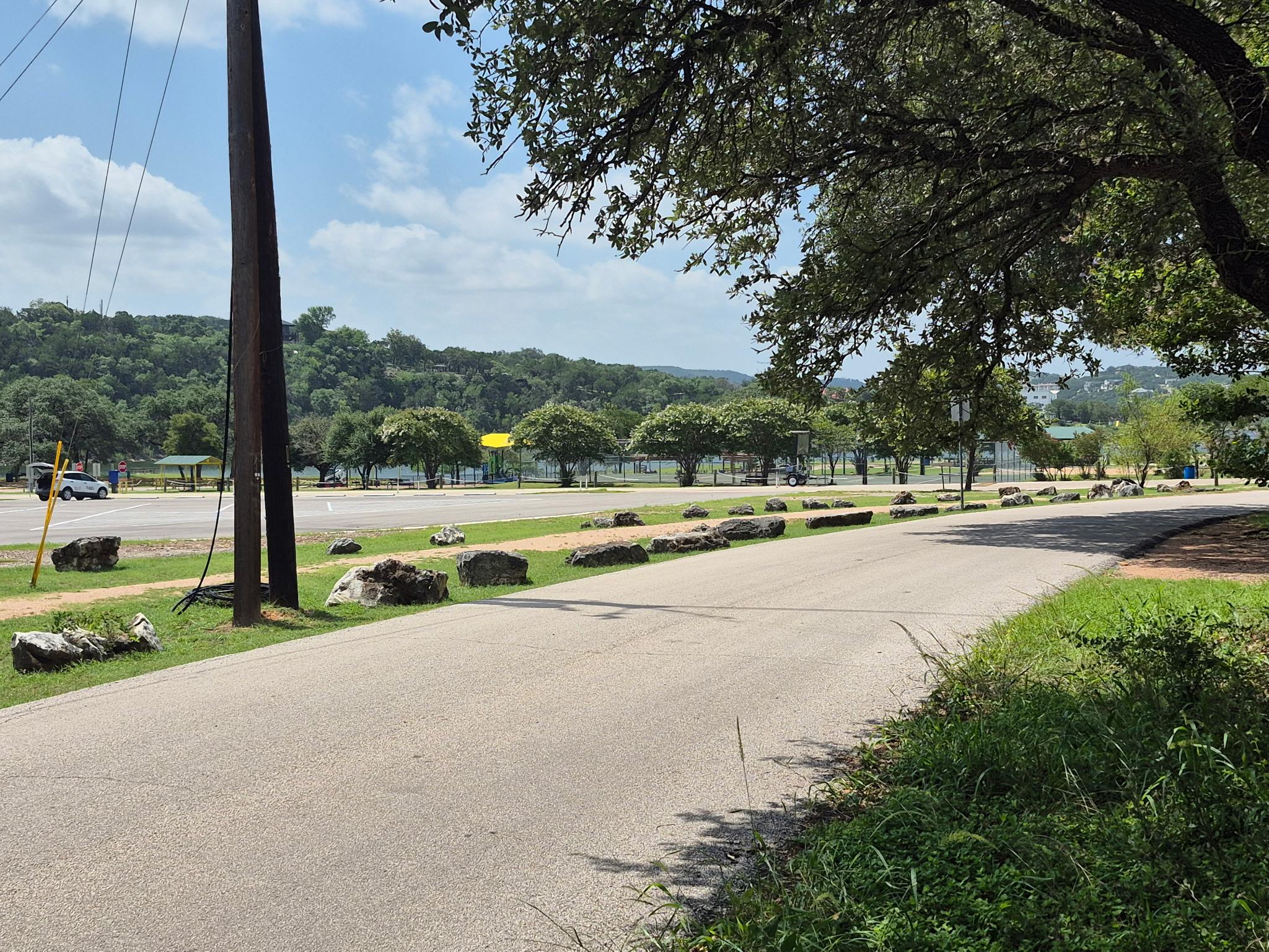 Paved road bordered by natural rock landscaping a