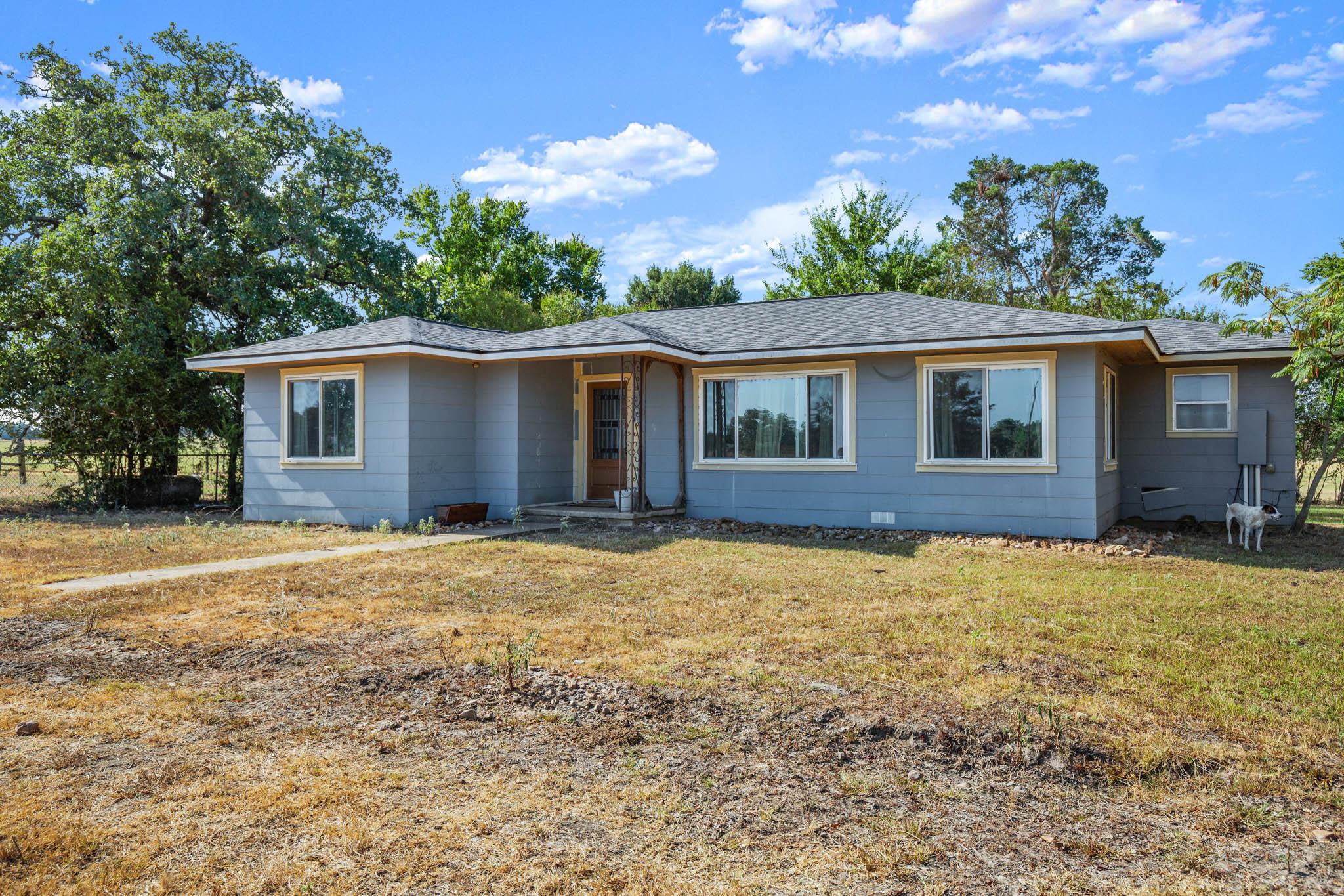 Ranch-style home with a front yard and a shingled