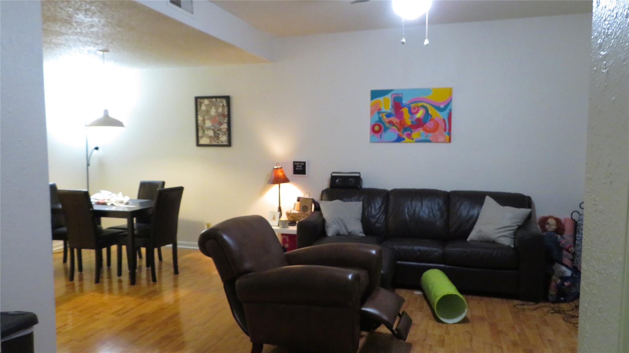 Living room featuring wood finished floors and ce