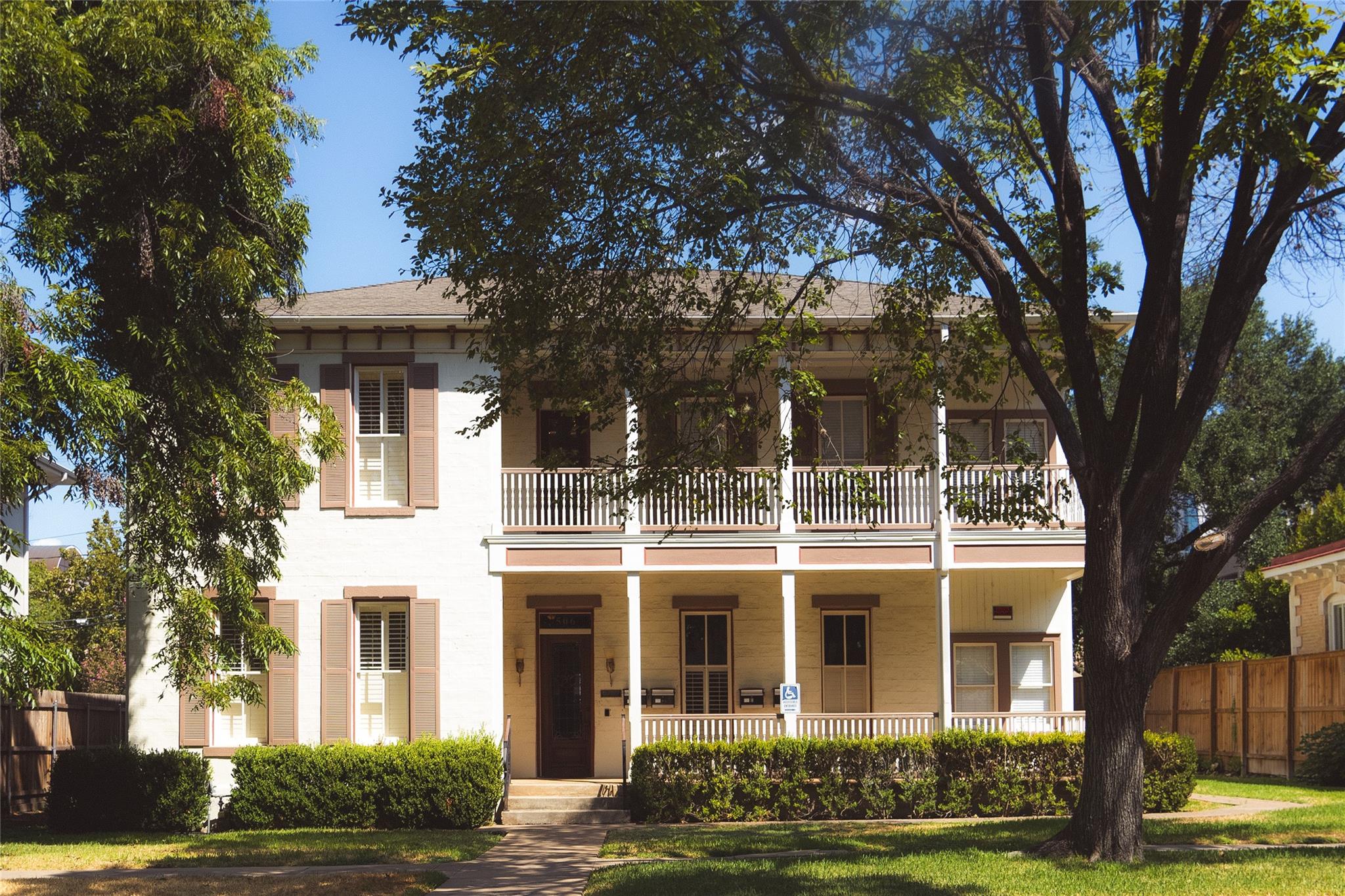 View of front of property with a porch and a balc