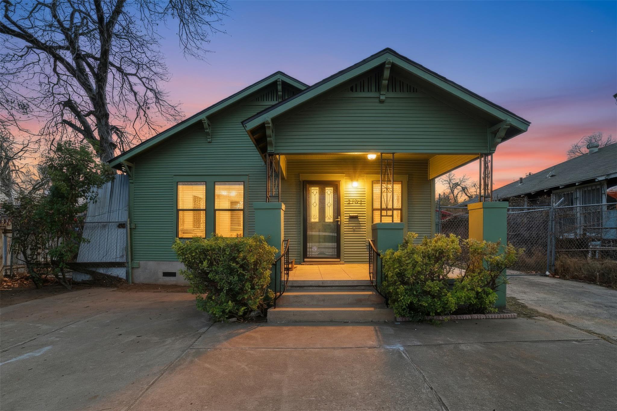 View of front of house with a porch, a gate, and 
