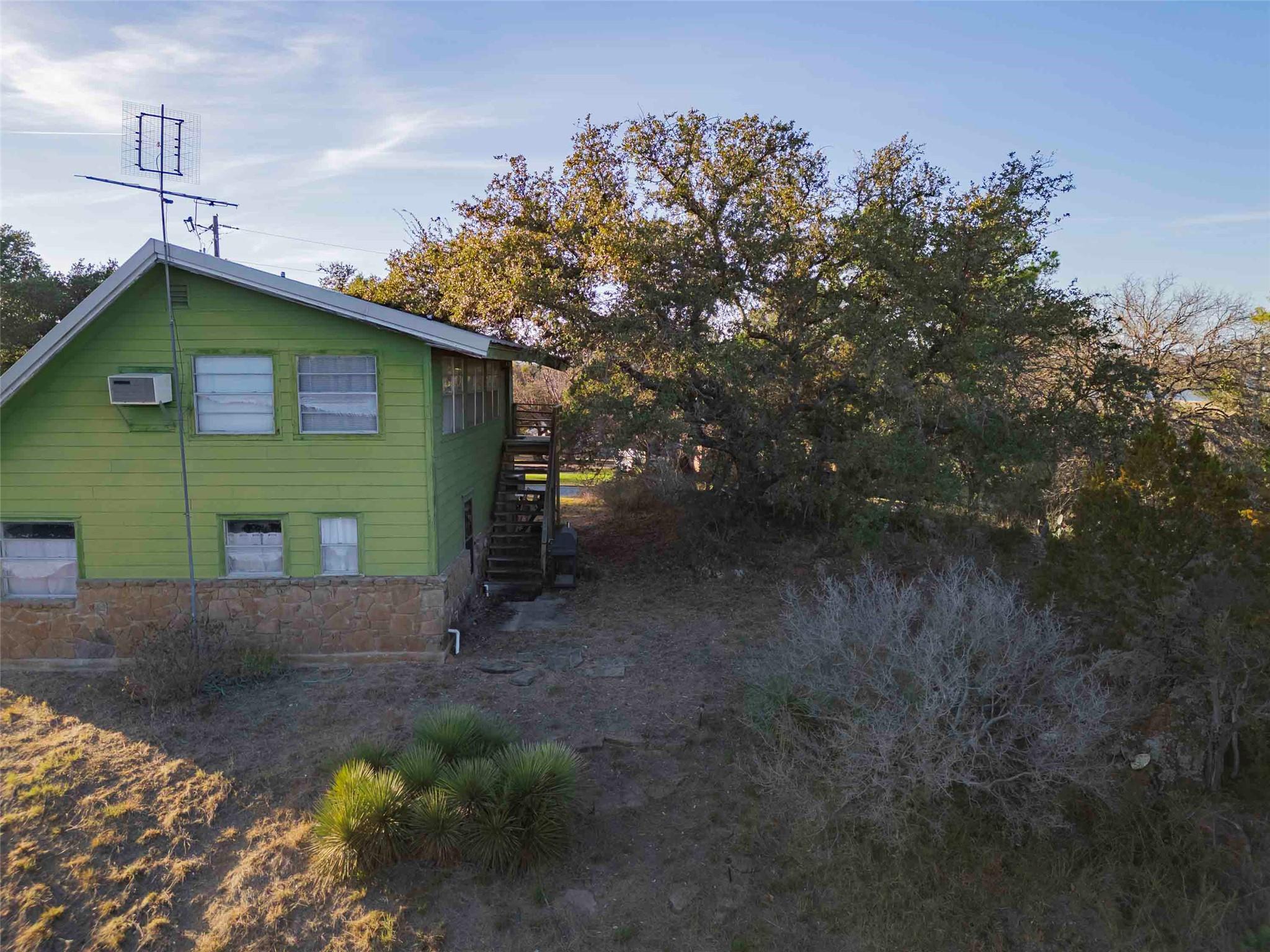 View of property exterior with stairway and a wal
