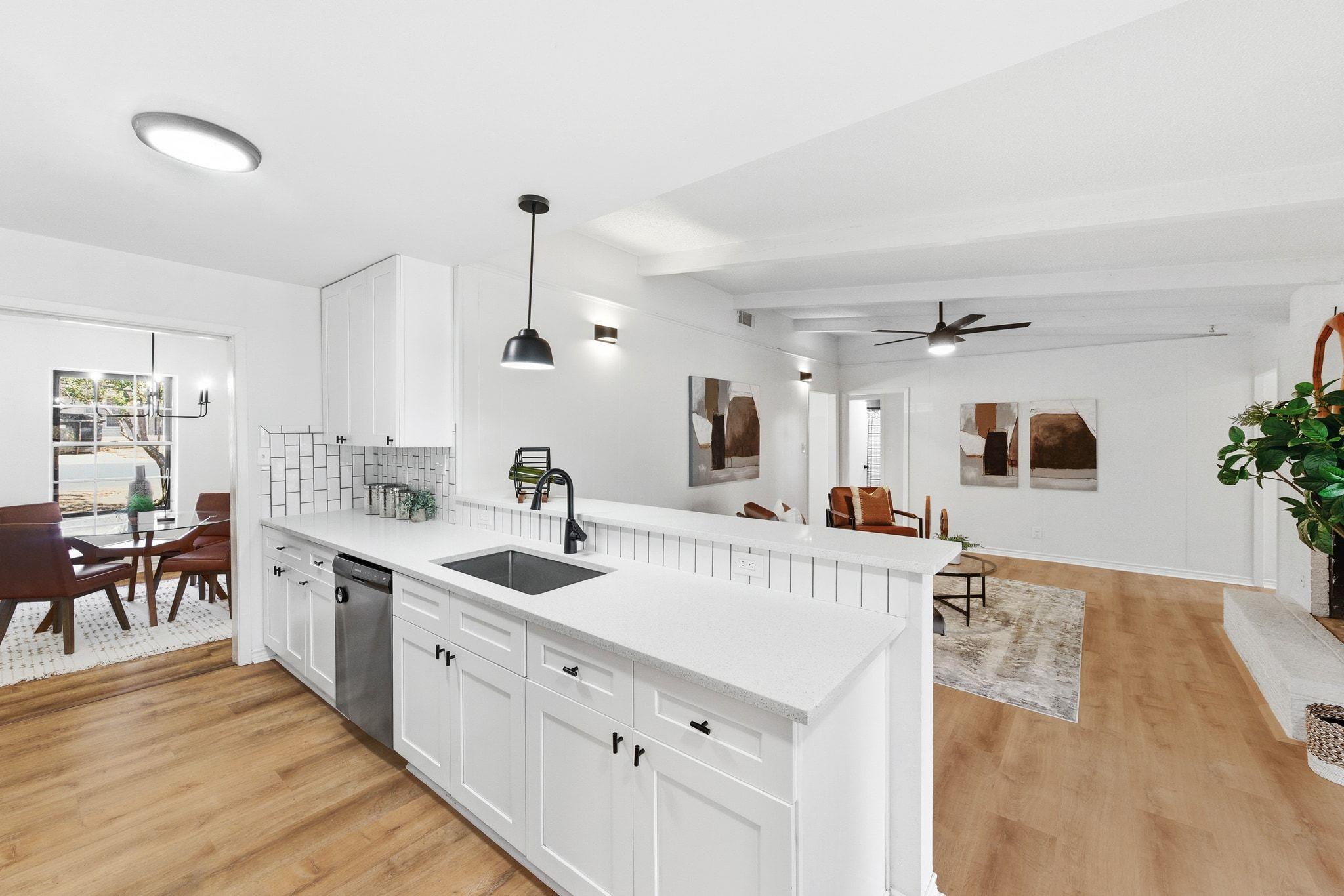 Kitchen featuring white cabinets, a peninsula, ha