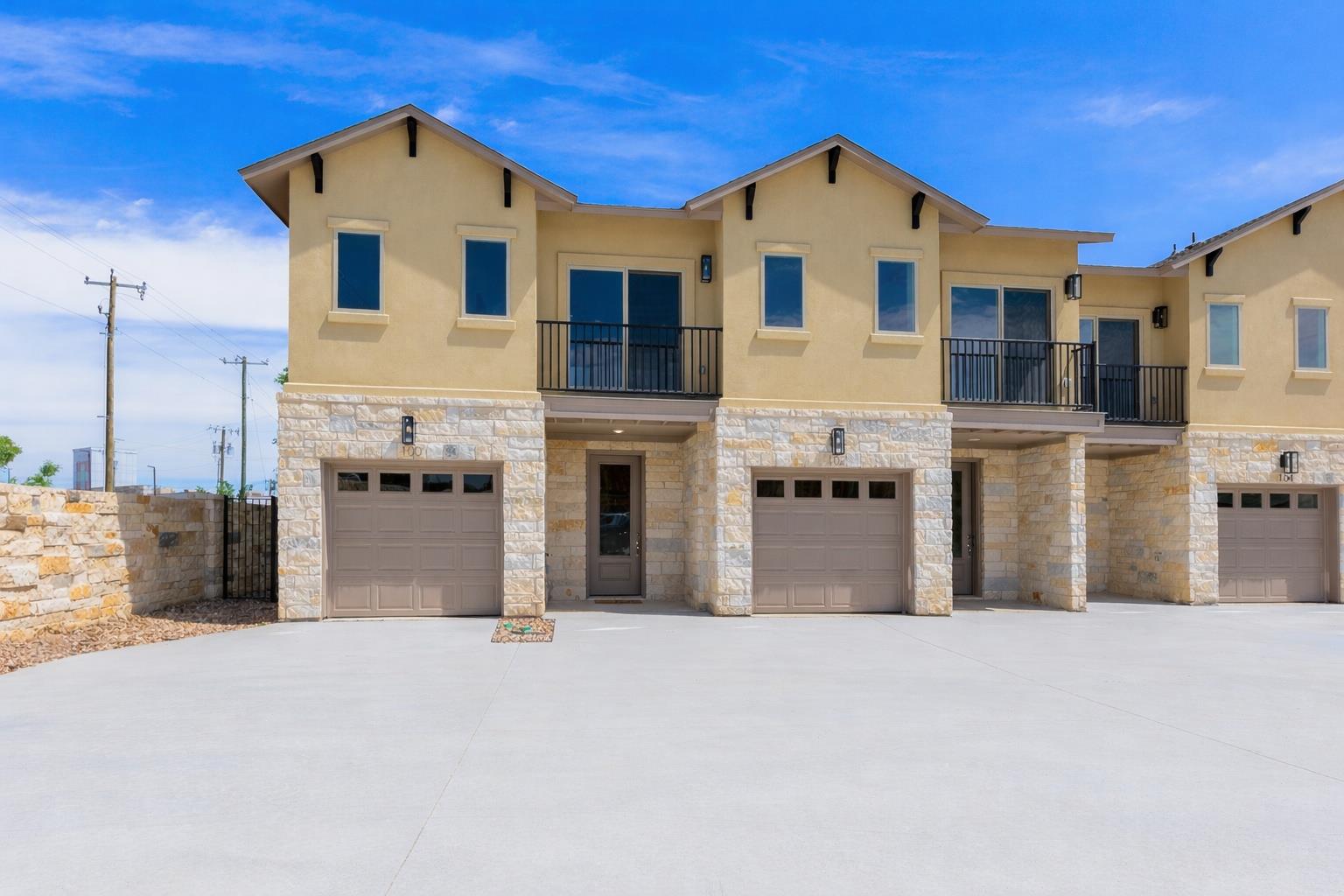 View of front facade featuring a balcony, stone s