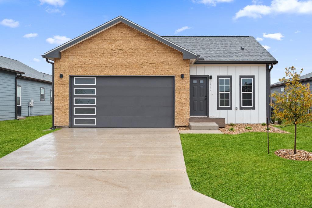 View of front of property with a front lawn, boar