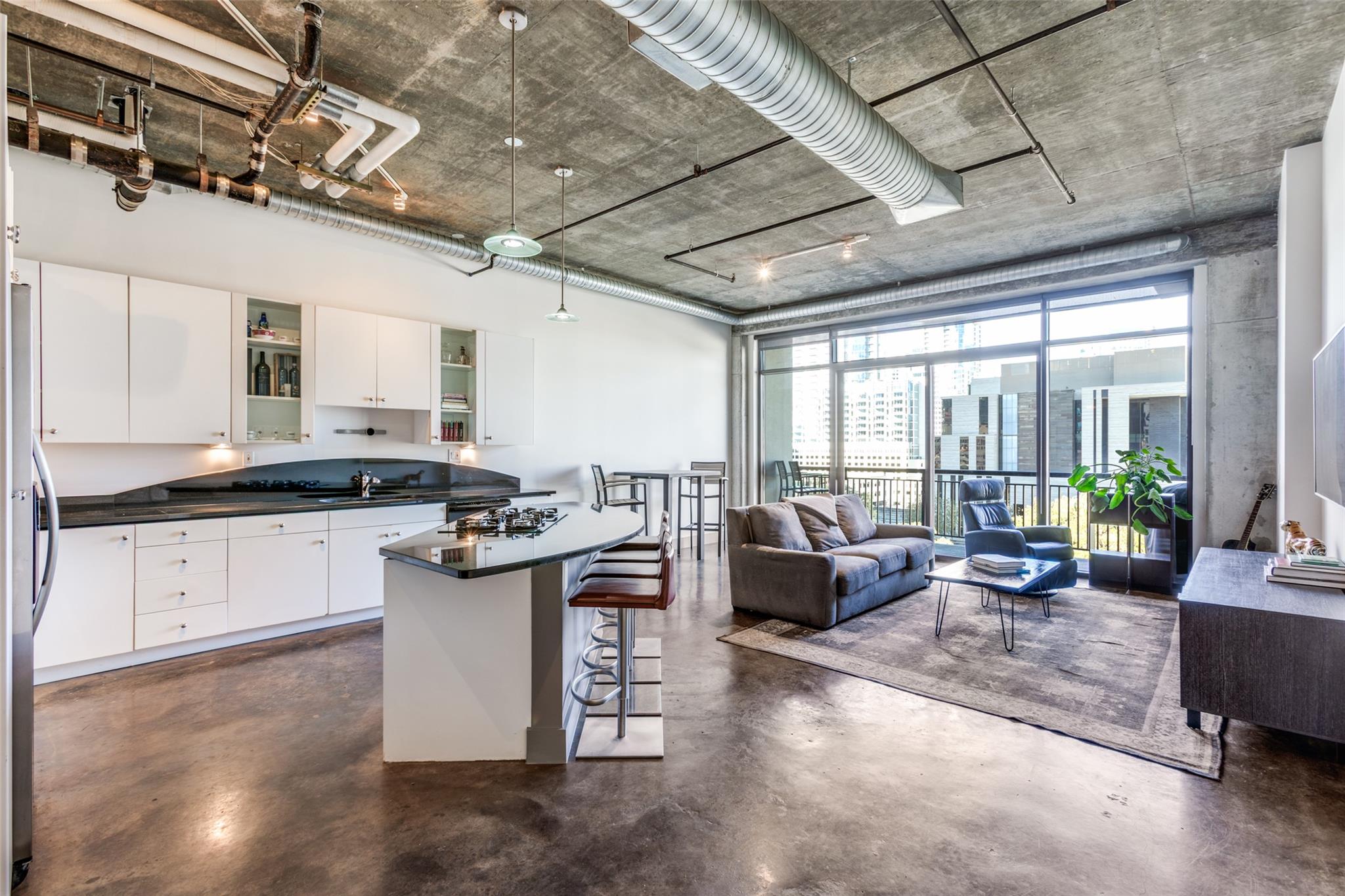 Kitchen featuring a breakfast bar area, concrete 