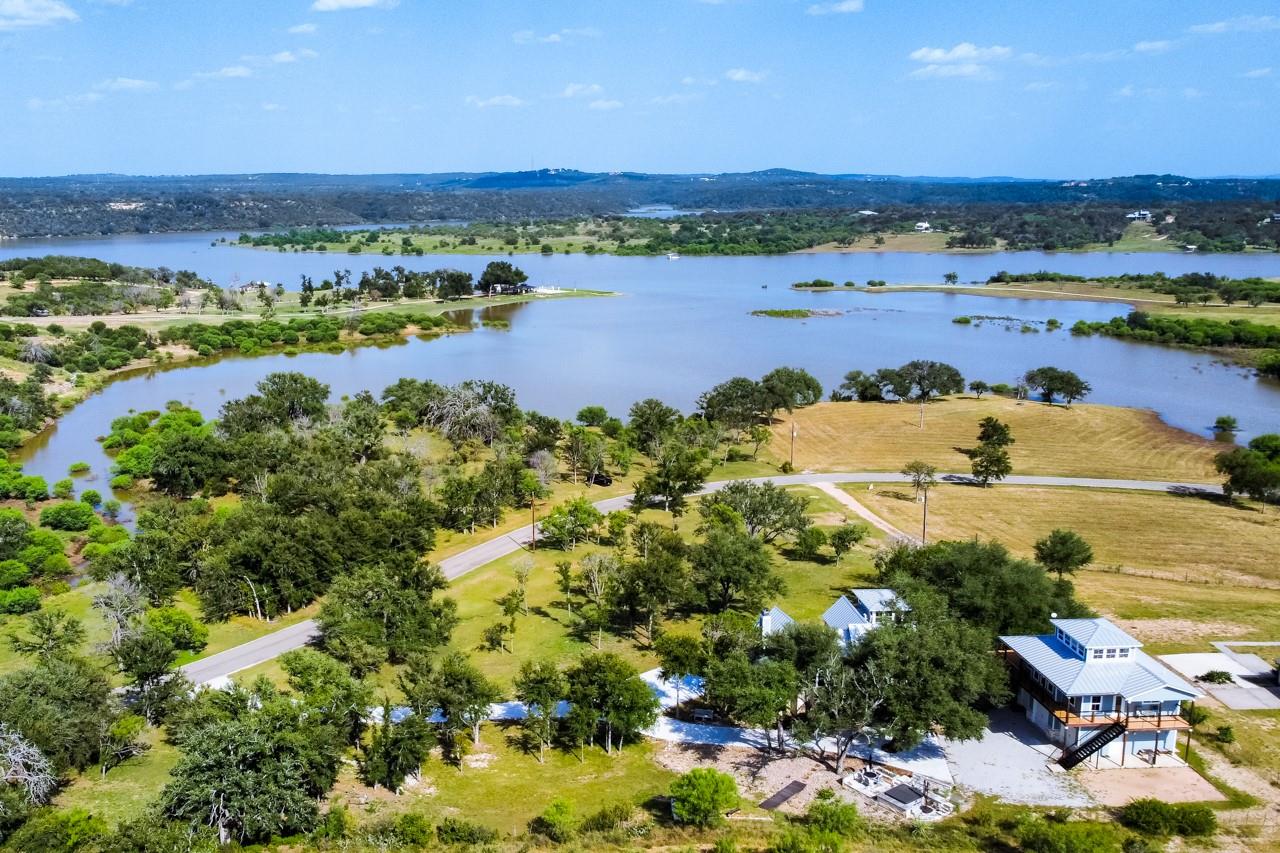 An aerial panorama reveals a waterfront residence