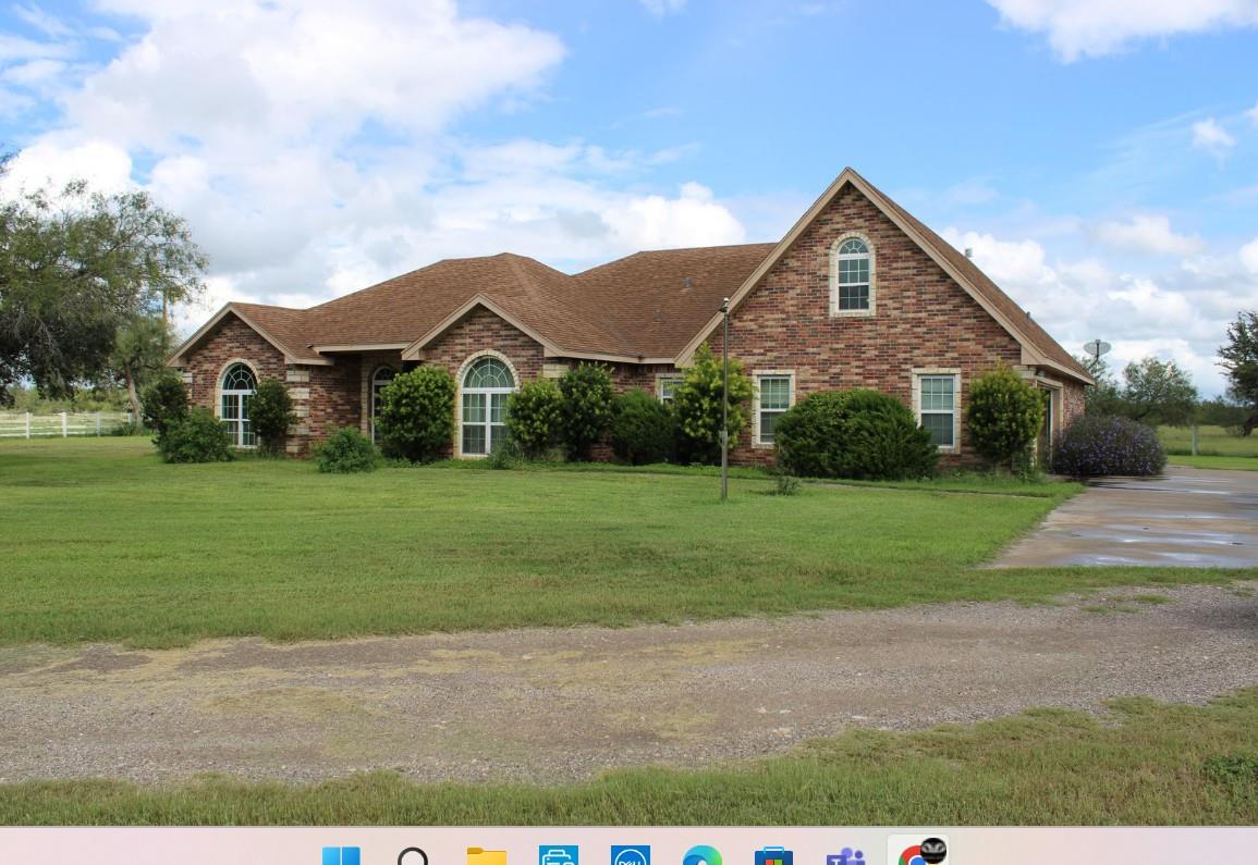 View of front of home with brick siding, a front 