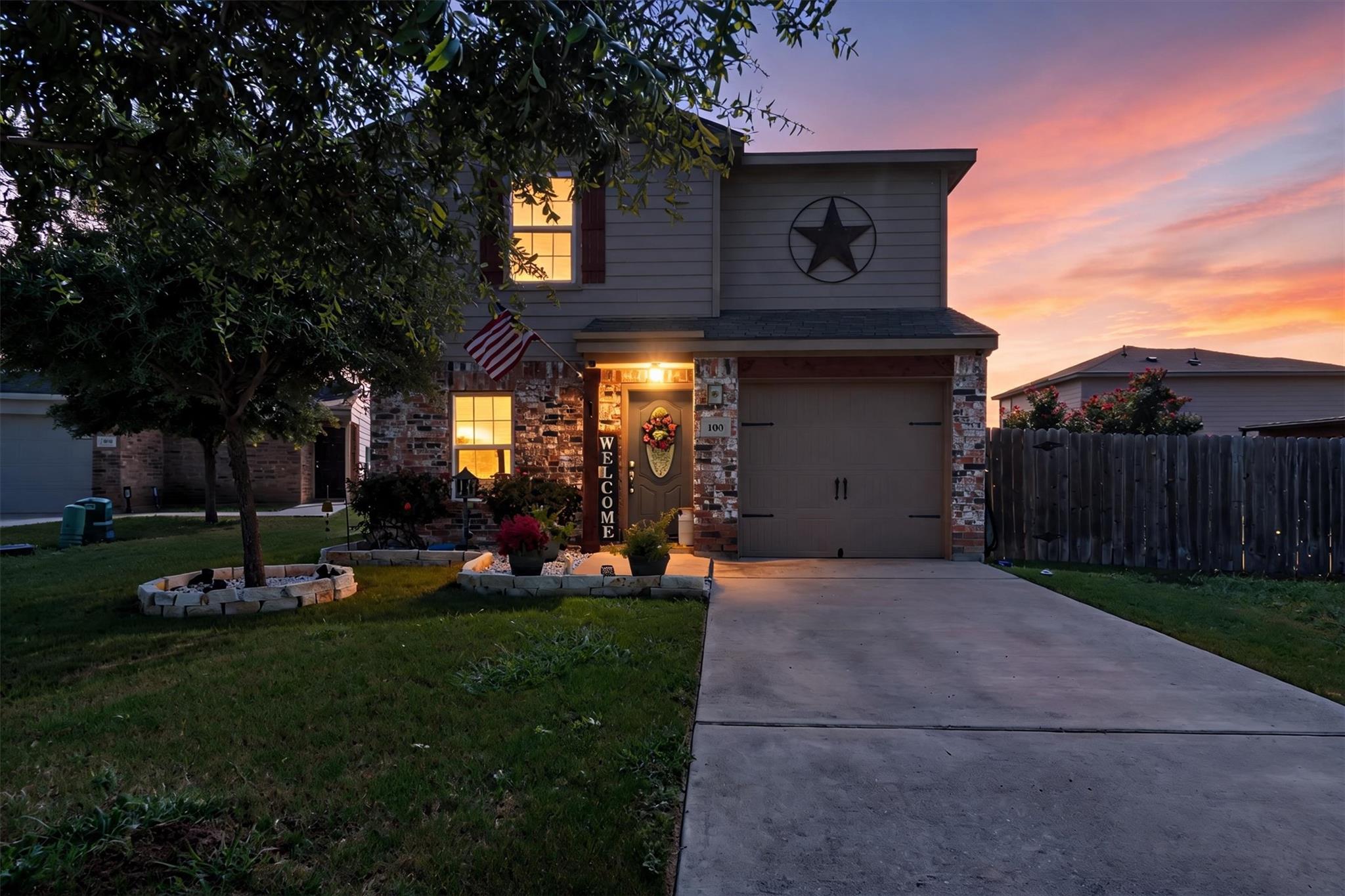 A welcoming front entrance features brick accents