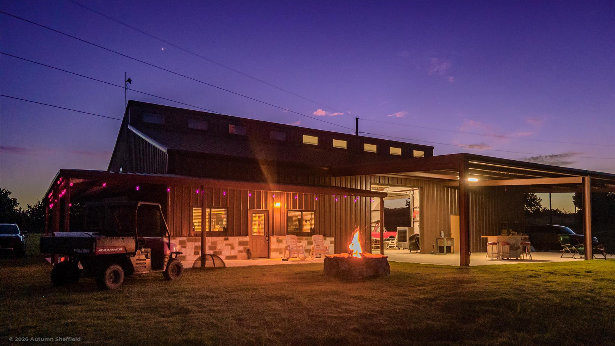 An expansive metal outbuilding anchors the backya