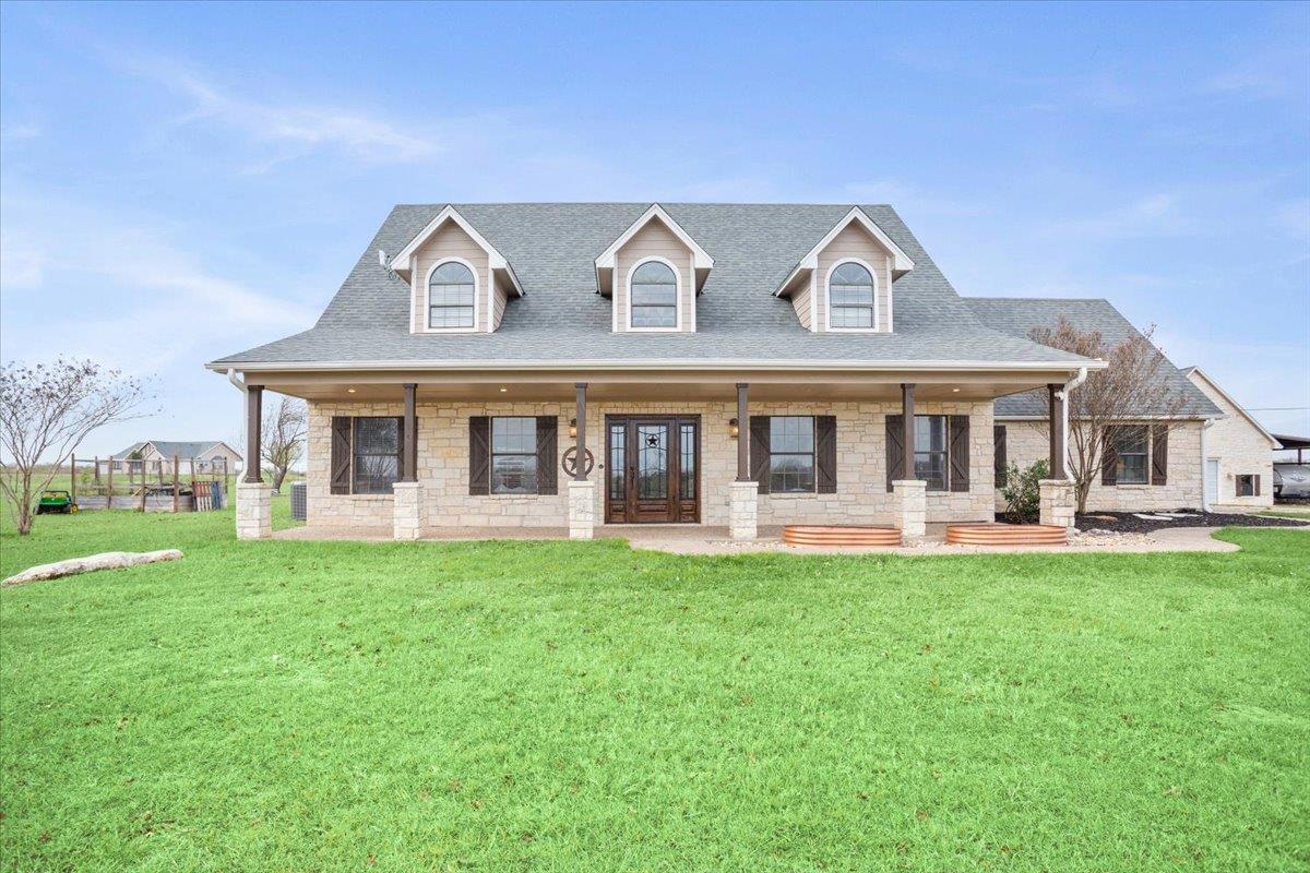 Cape cod-style house featuring a porch, a front l