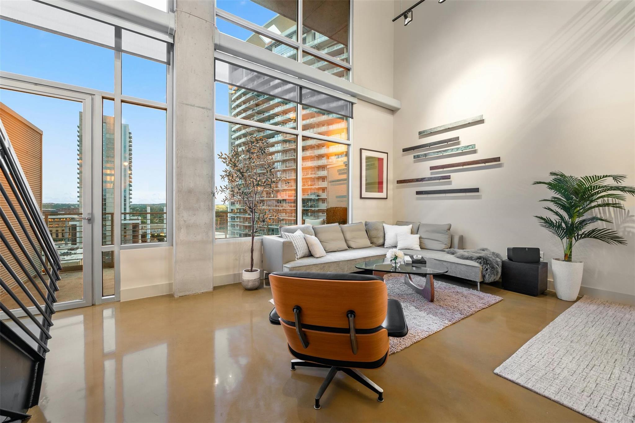 Living room featuring finished concrete flooring,