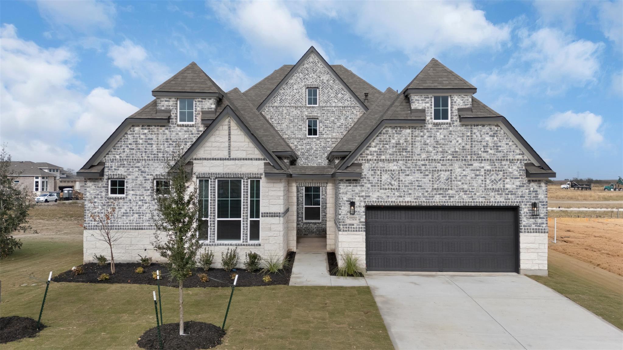 French country inspired facade with driveway, a f