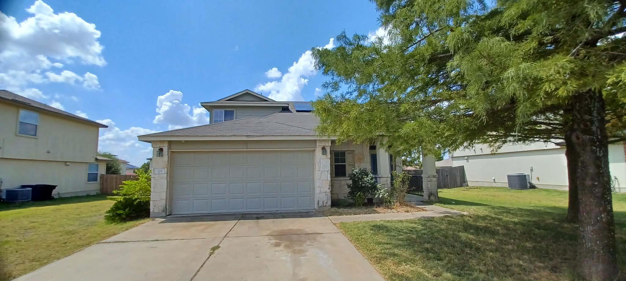 View of front facade featuring concrete driveway,