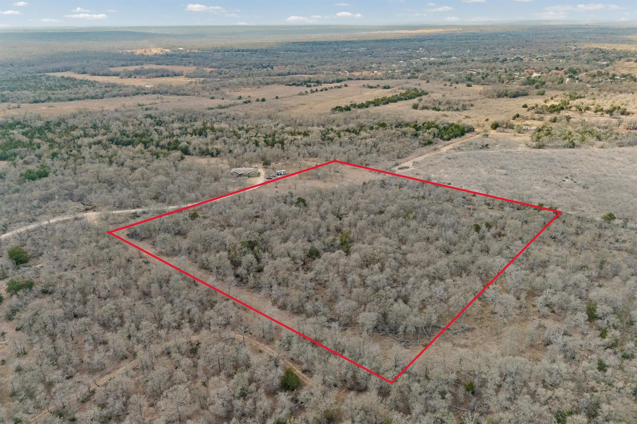Aerial view of property and surrounding area with