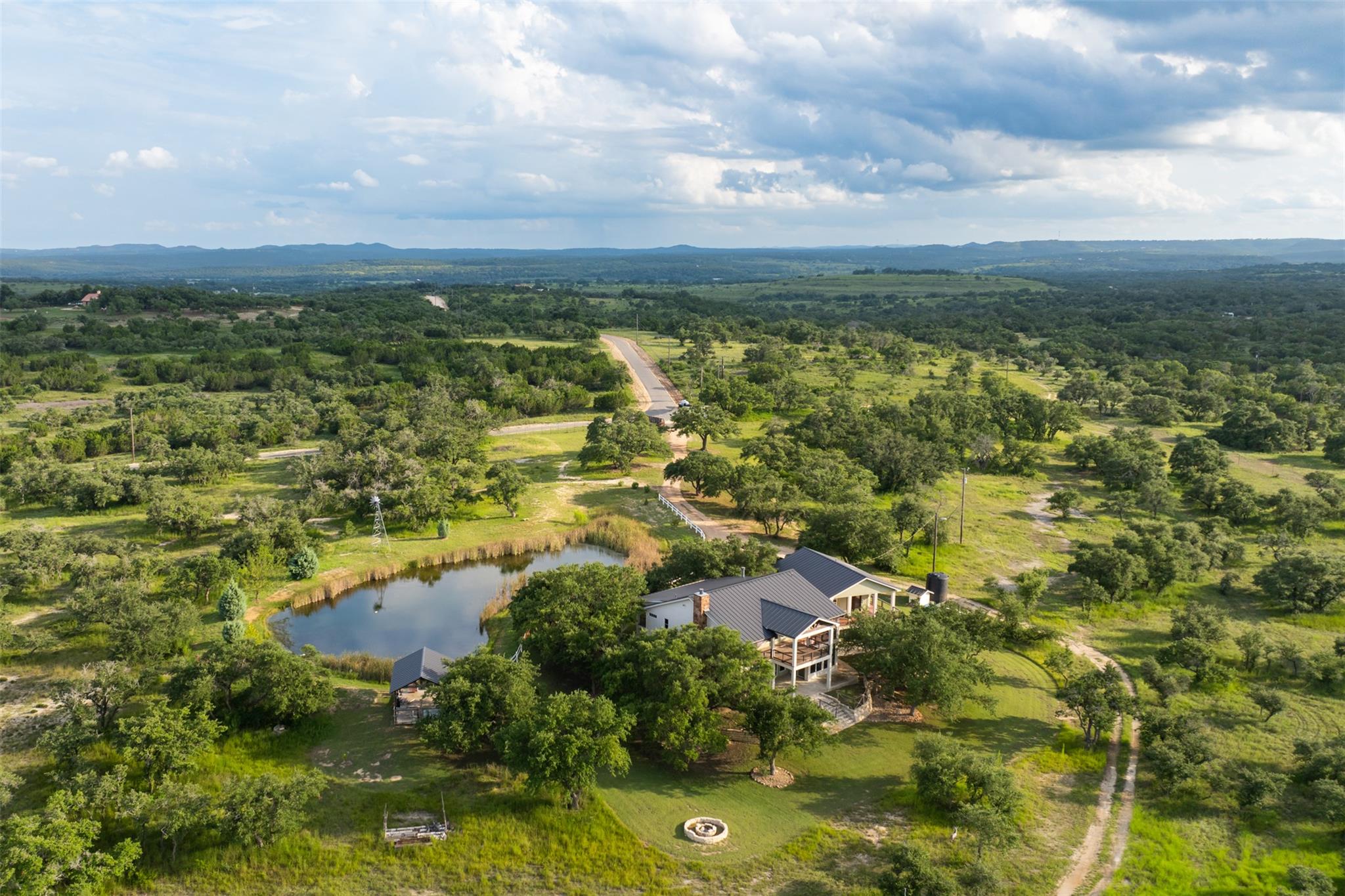 View of property location with a heavily wooded a