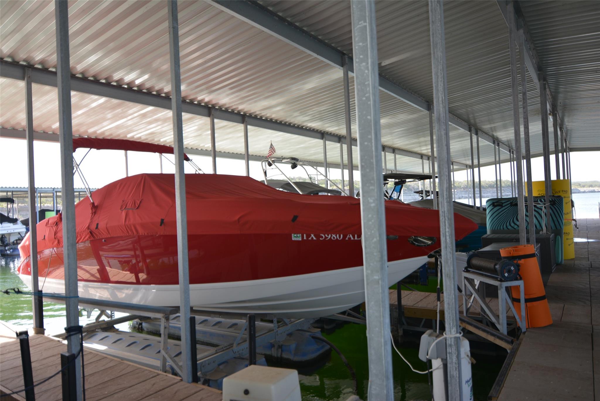 Covered boat slip featuring a metal roof structur