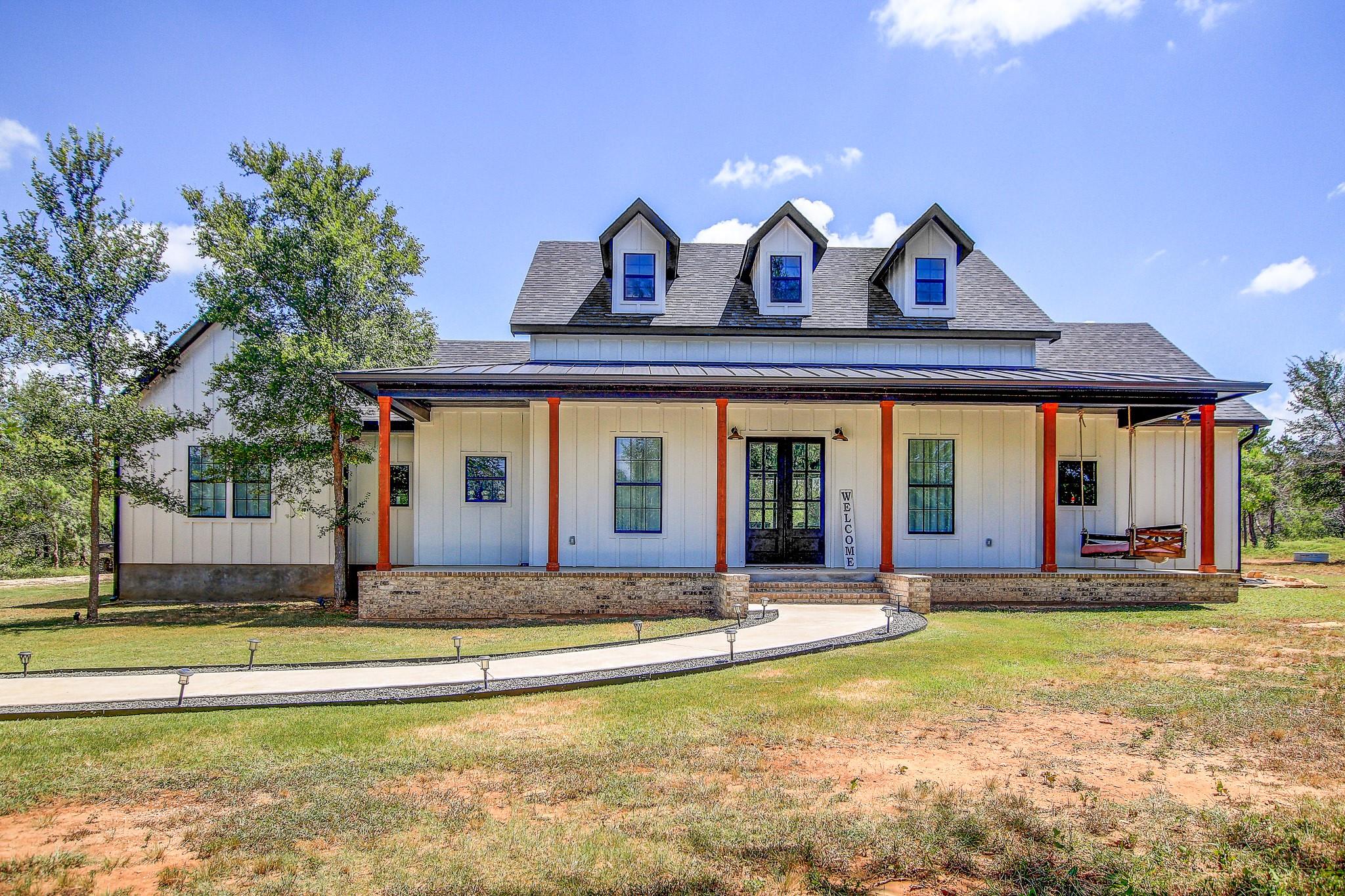 A charming farmhouse-style residence with a welco