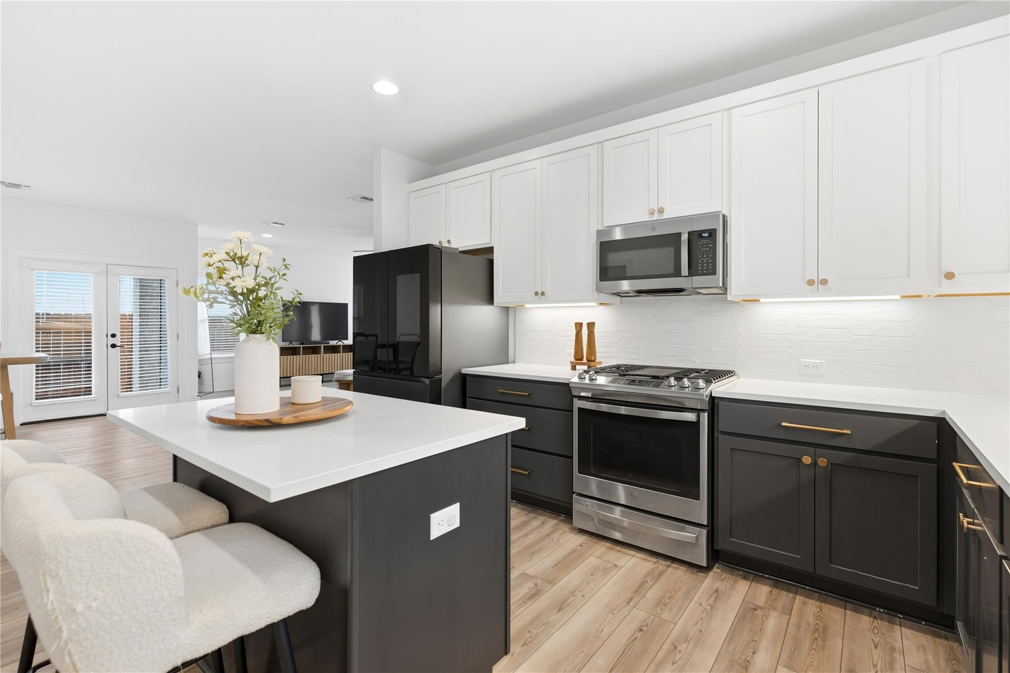 Kitchen featuring white cabinets, stainless steel
