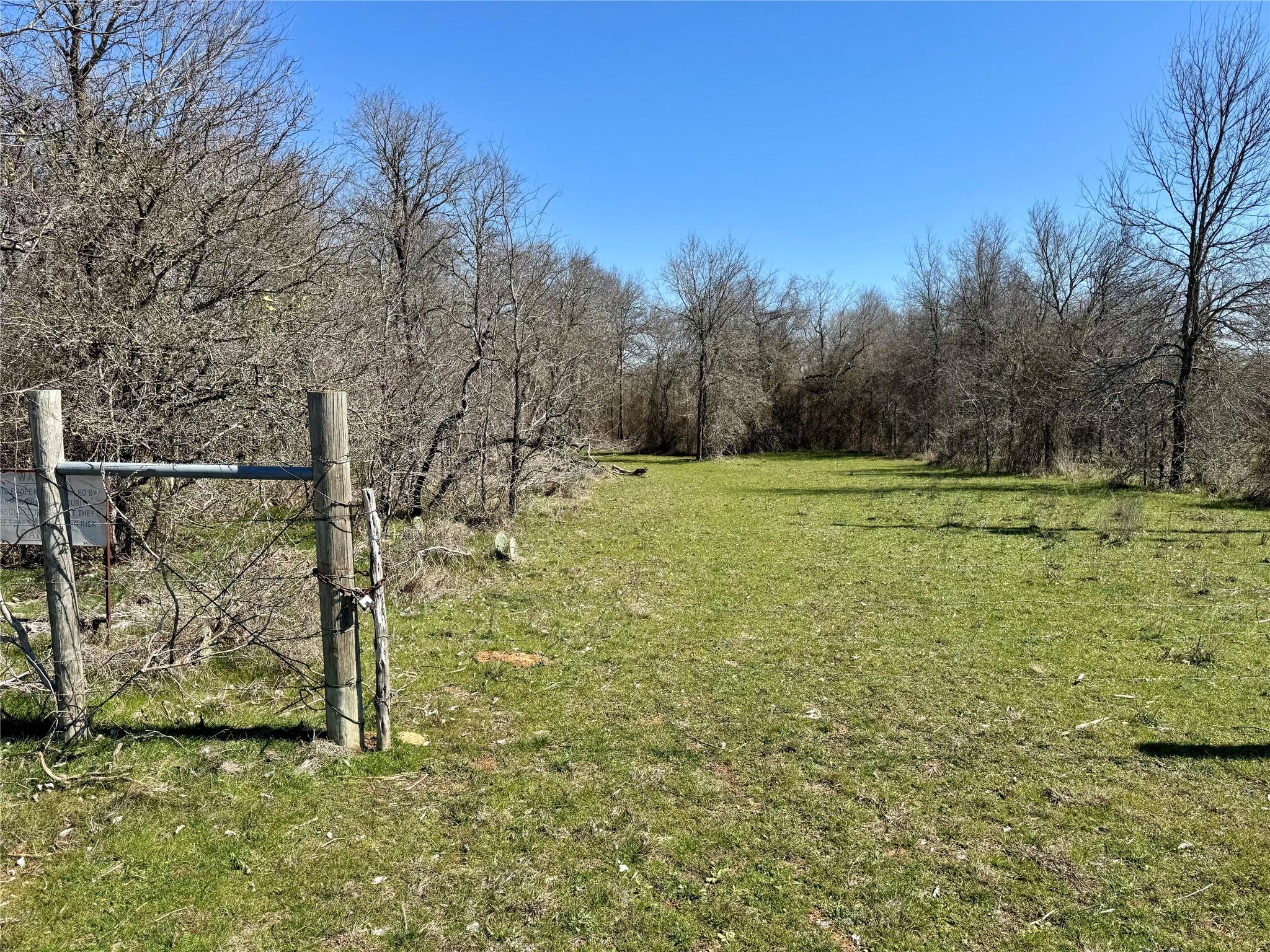 View of green lawn featuring a gate