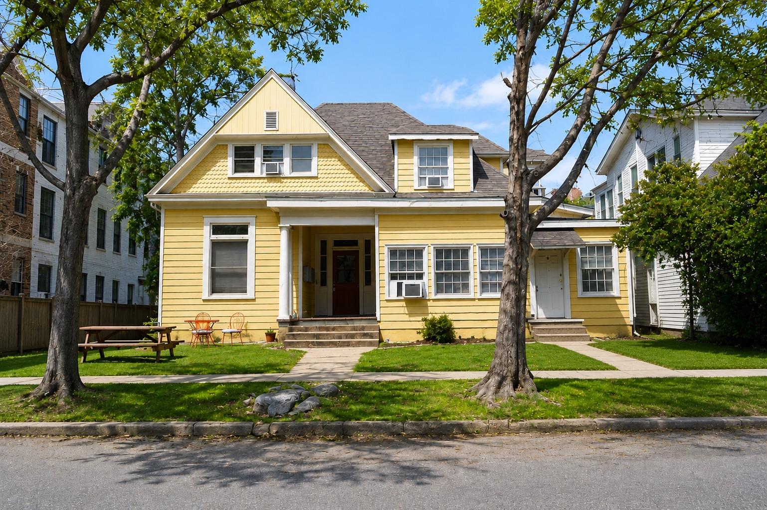A cheerful yellow exterior with traditional windo