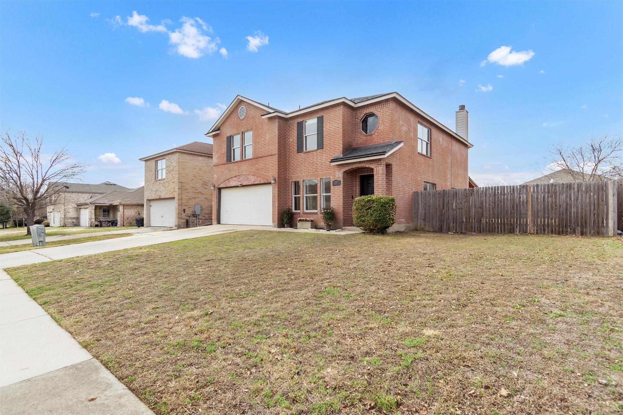 Traditional-style home featuring brick siding, a 