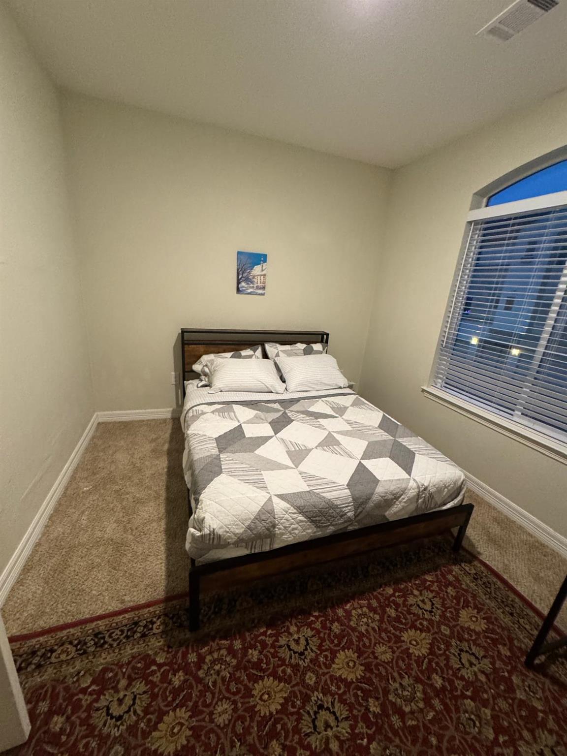Carpeted bedroom featuring baseboards