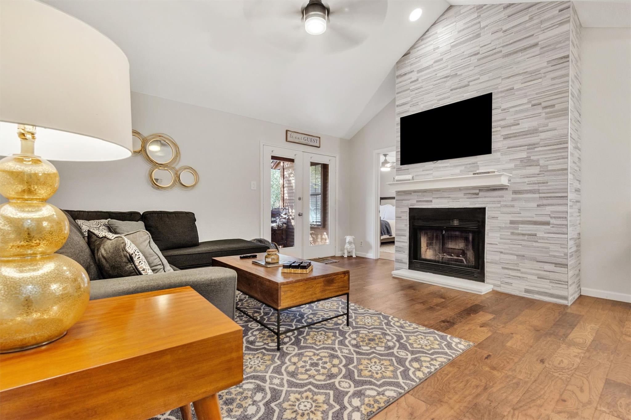 Living area featuring high vaulted ceiling, wood 