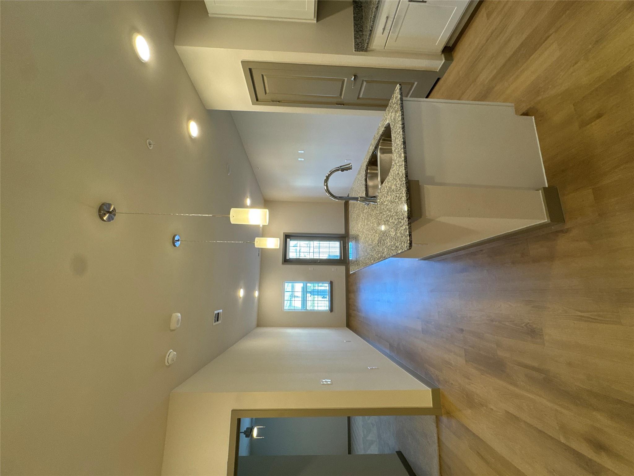 Kitchen featuring light stone countertops, decora