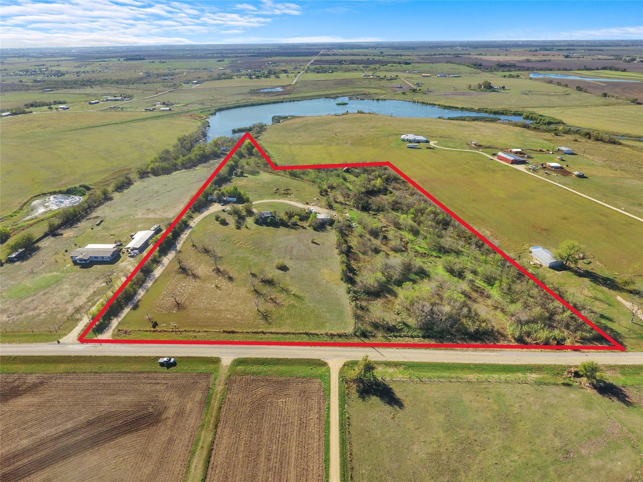 View of rural area with a nearby body of water an