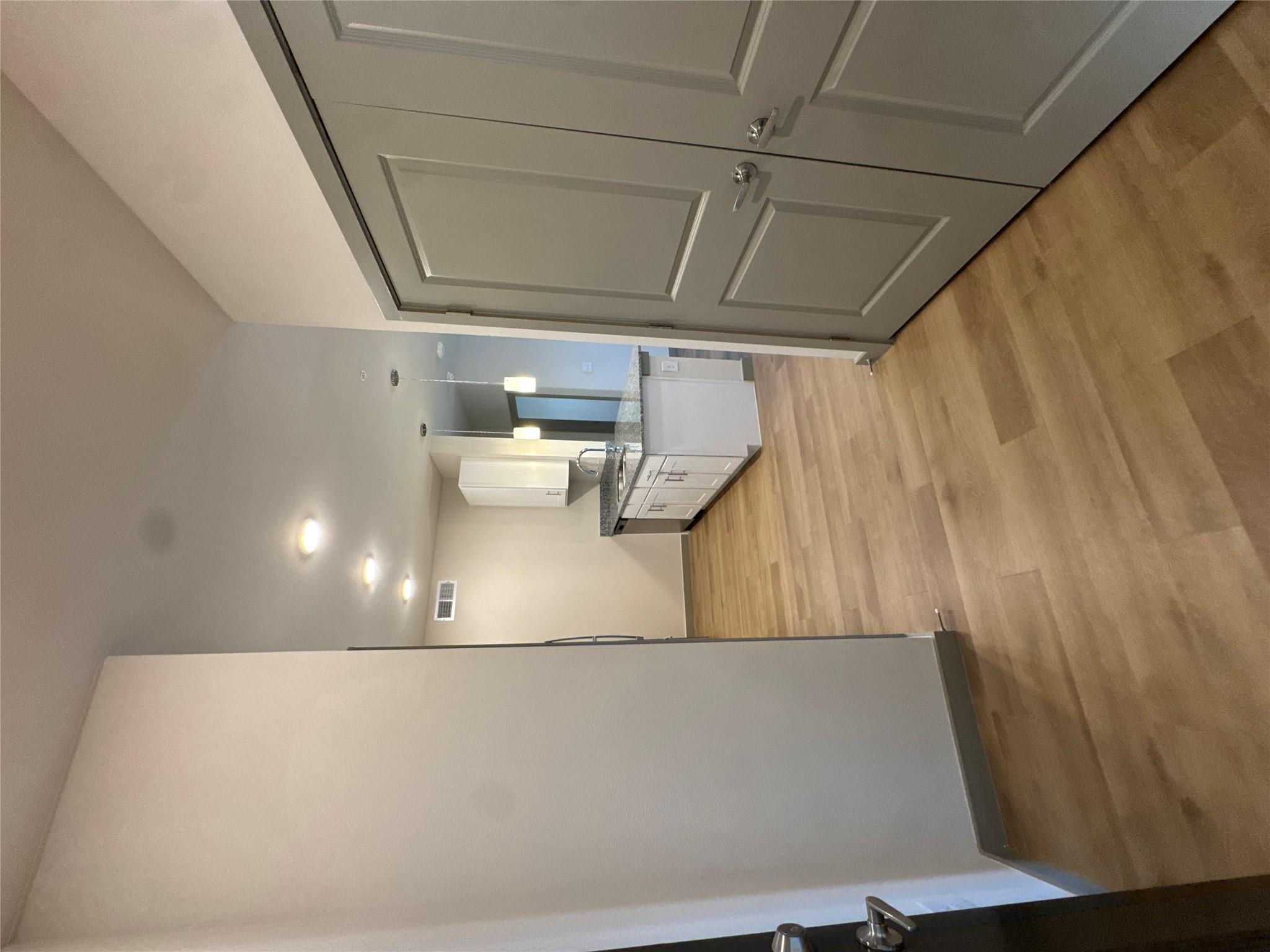 Hall featuring light wood-style floors and basebo