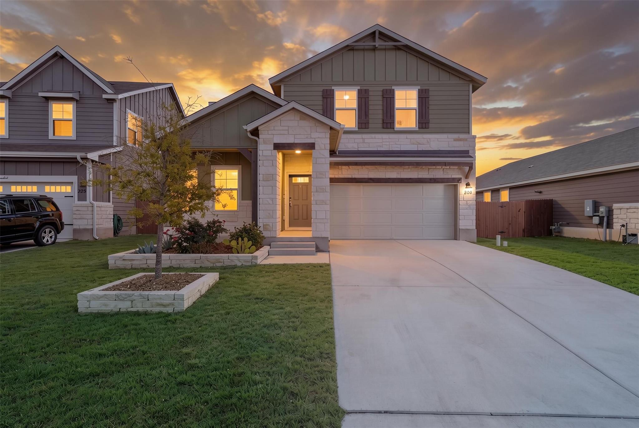 A welcoming stone and siding facade offers excell