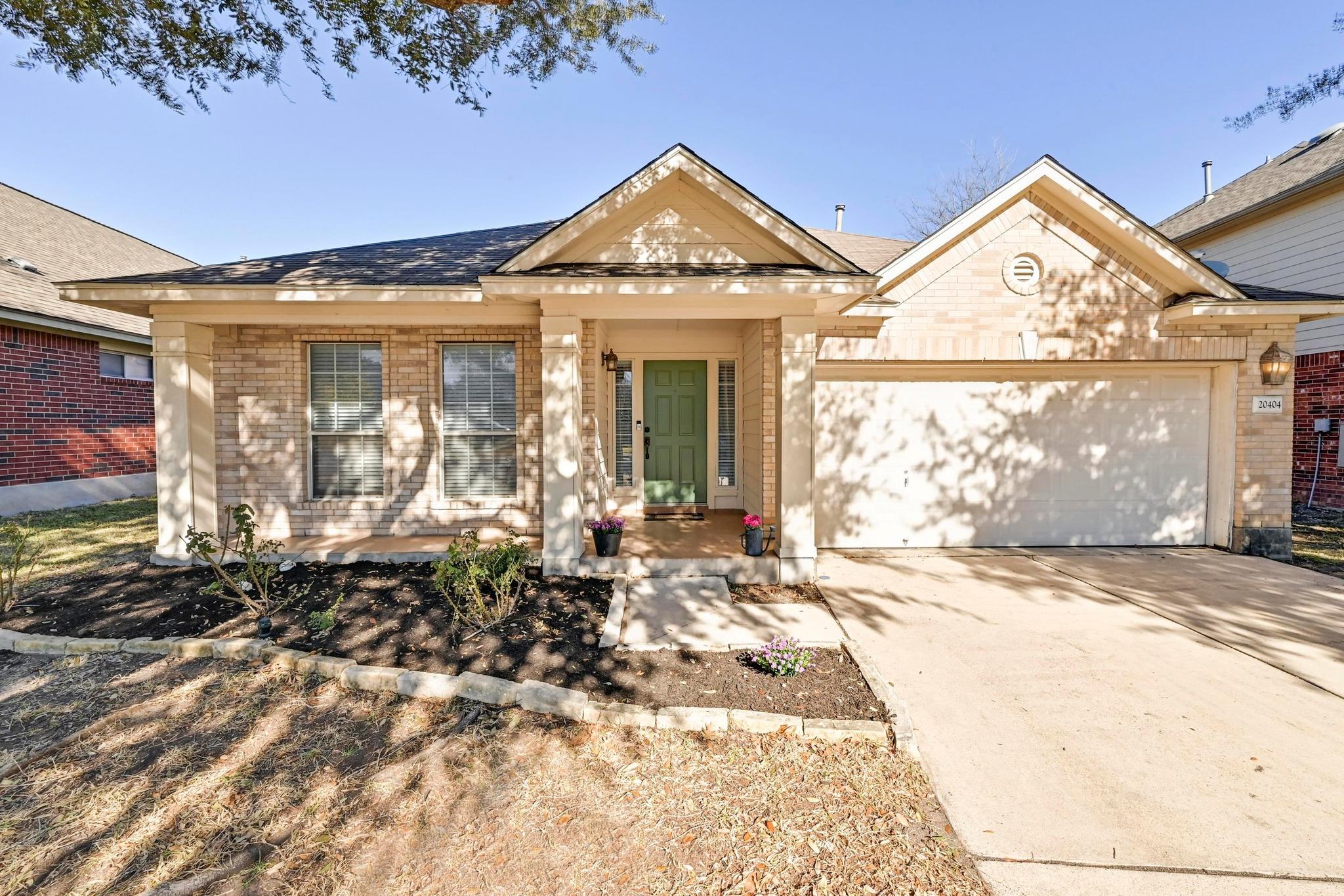 Ranch-style home with brick siding, concrete driv