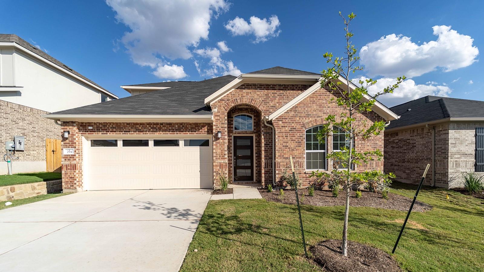 Ranch-style house with an attached garage, drivew