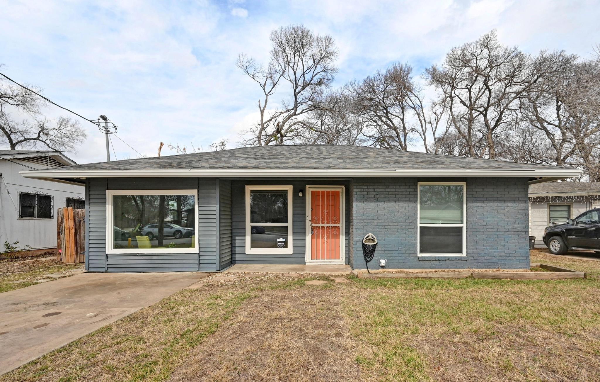 Single story home with roof with shingles and bri