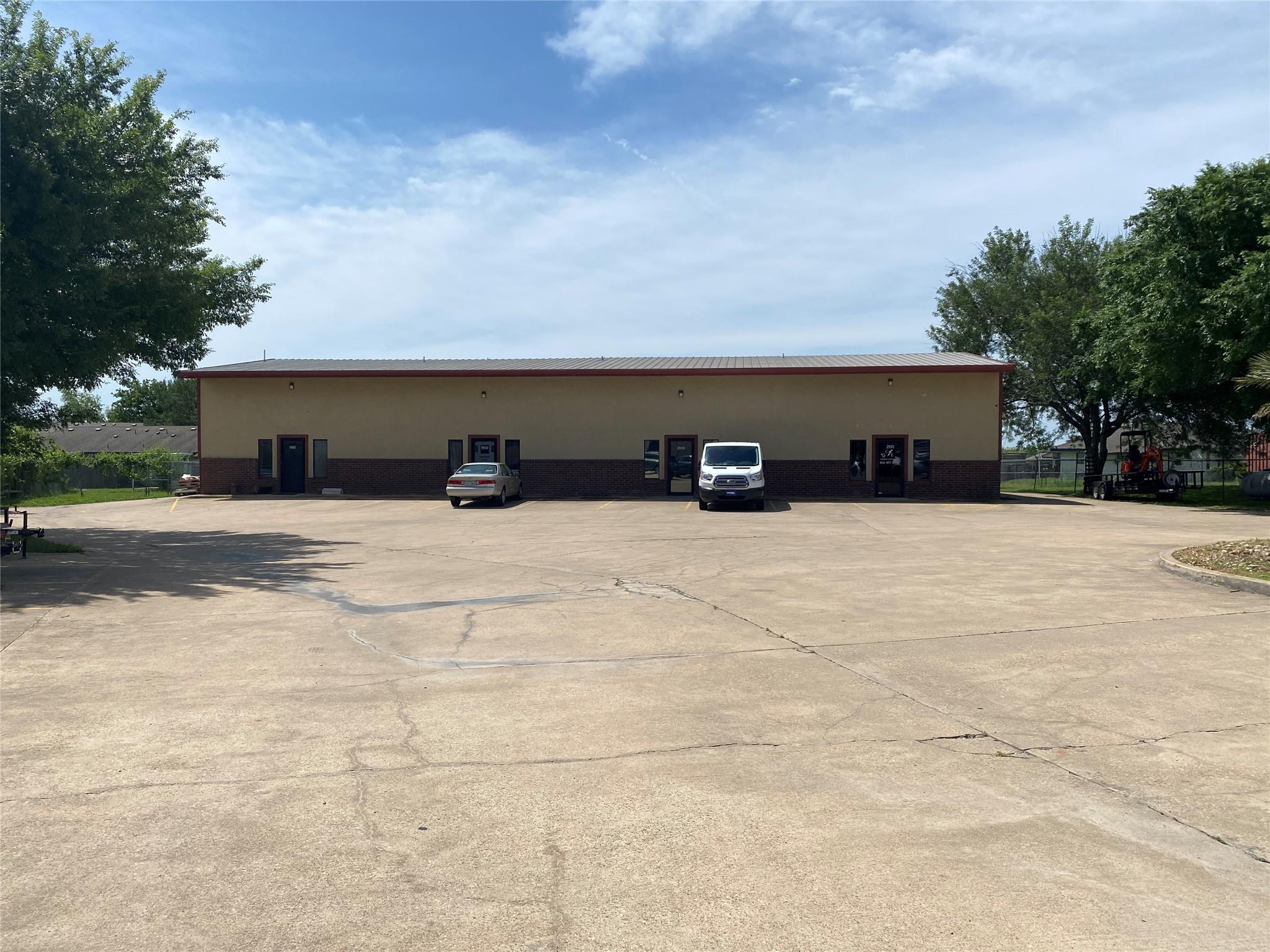 View of property featuring uncovered parking