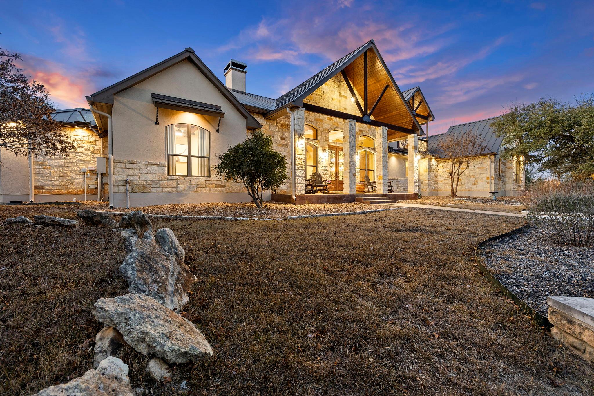 View of front of home with stone siding and a chi