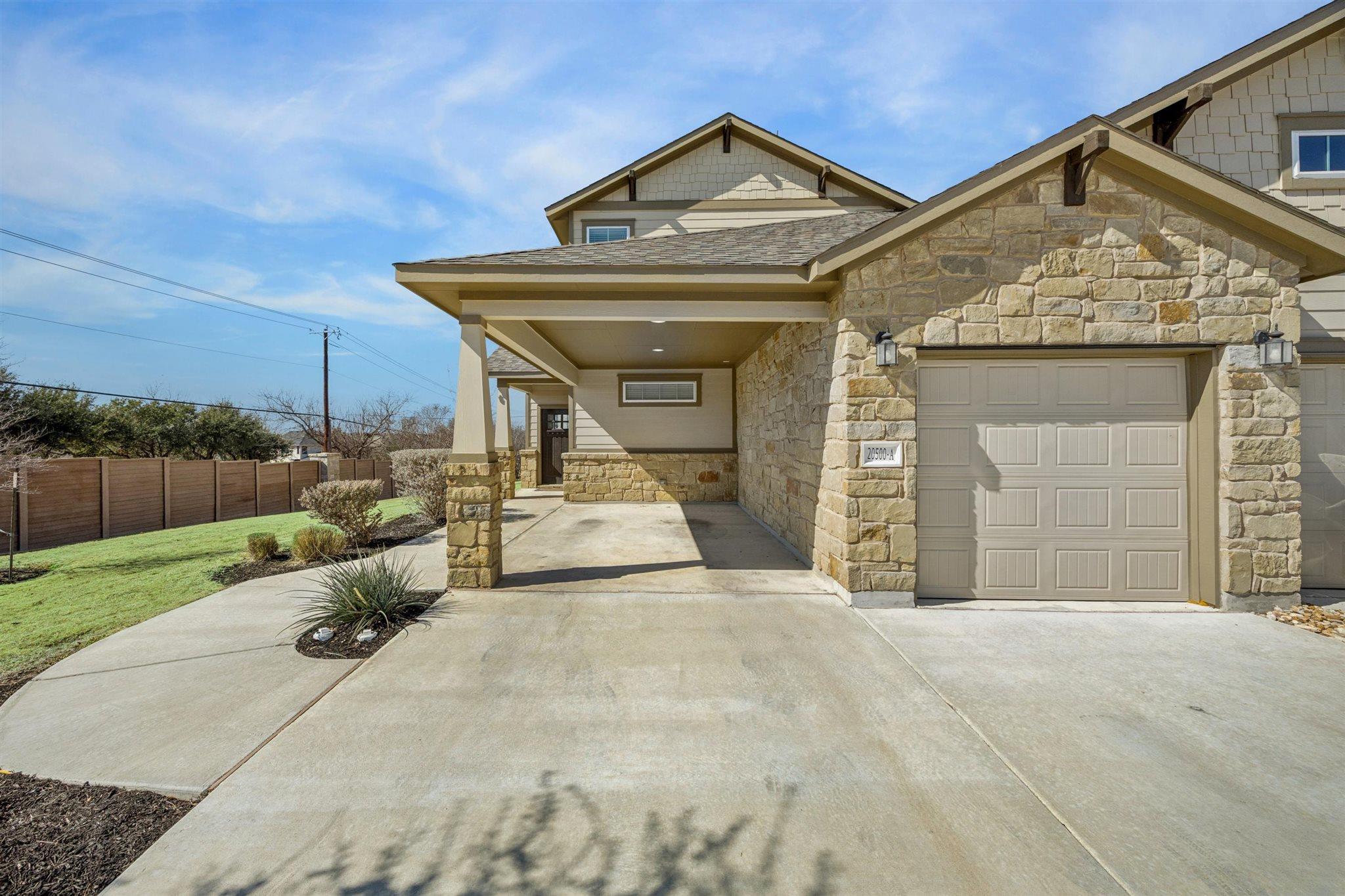 View of front of property featuring stone siding,
