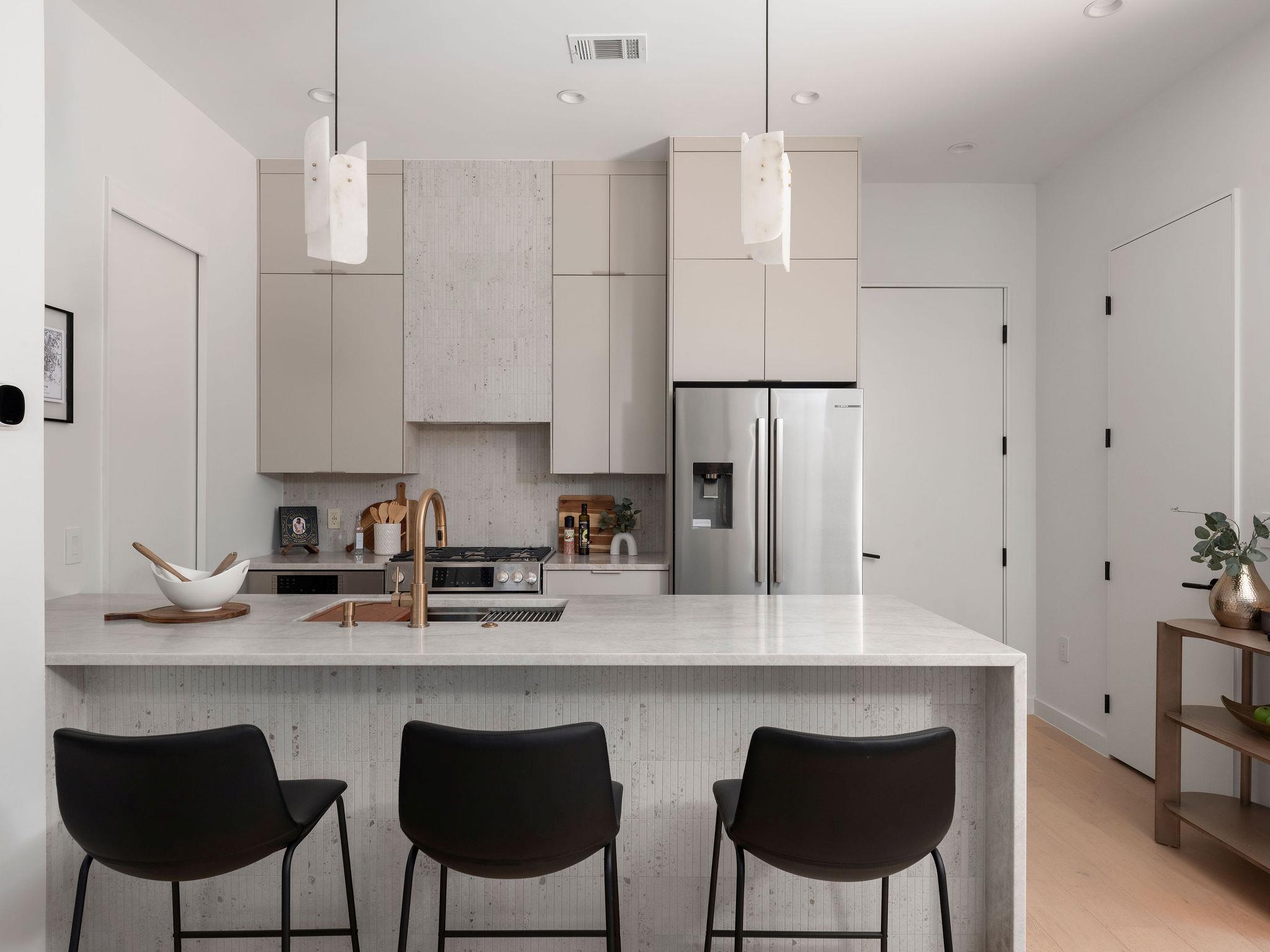 Streamlined cabinetry and a waterfall island crea