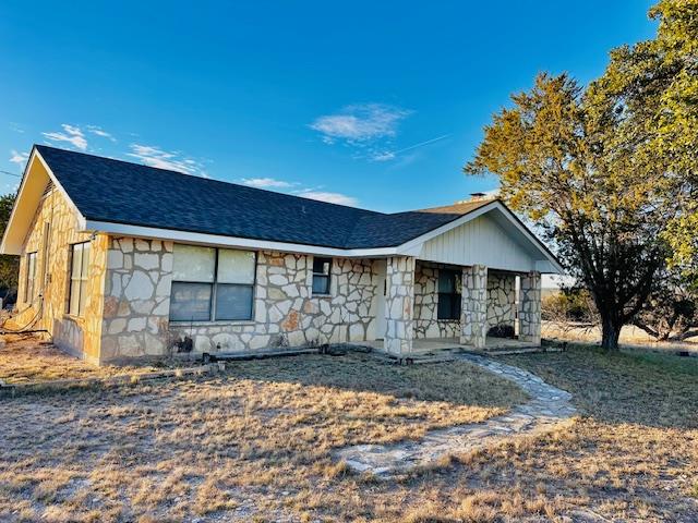 View of front facade featuring stone siding and r