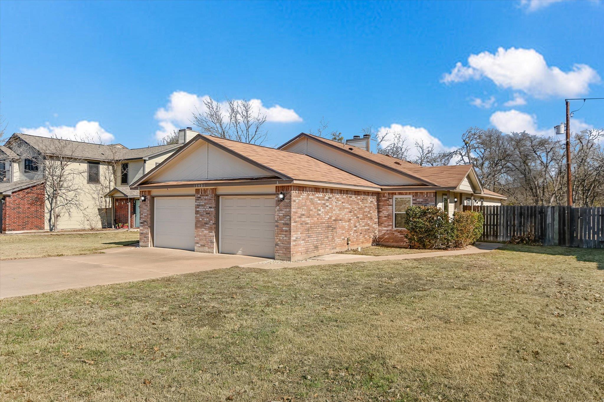 Ranch-style home with concrete driveway, an attac