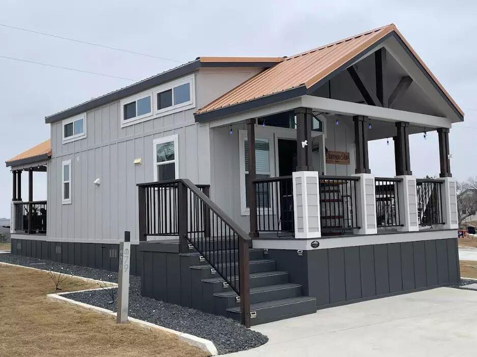 View of front of property with a metal roof and b