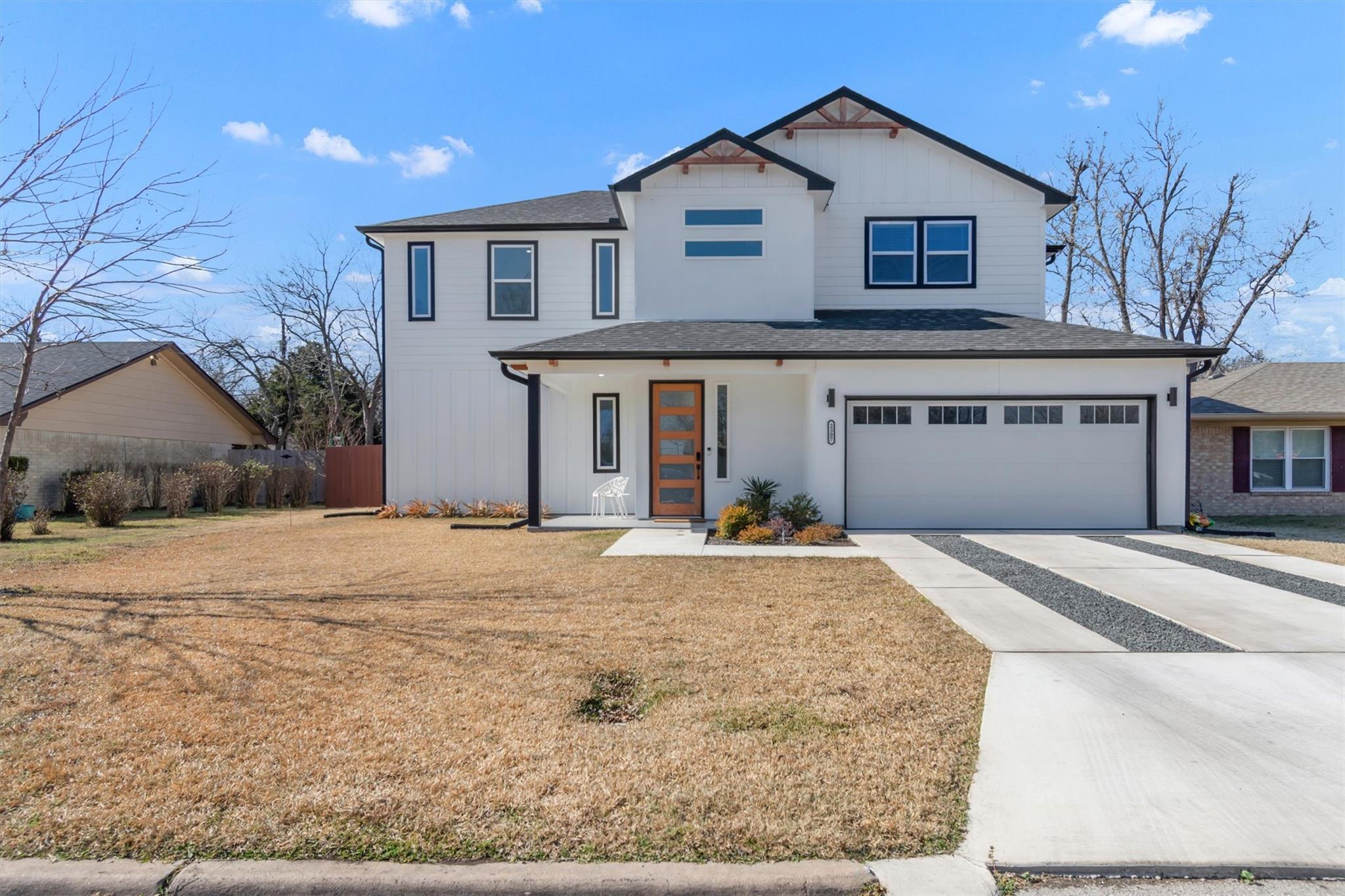 View of front of property with driveway, an attac