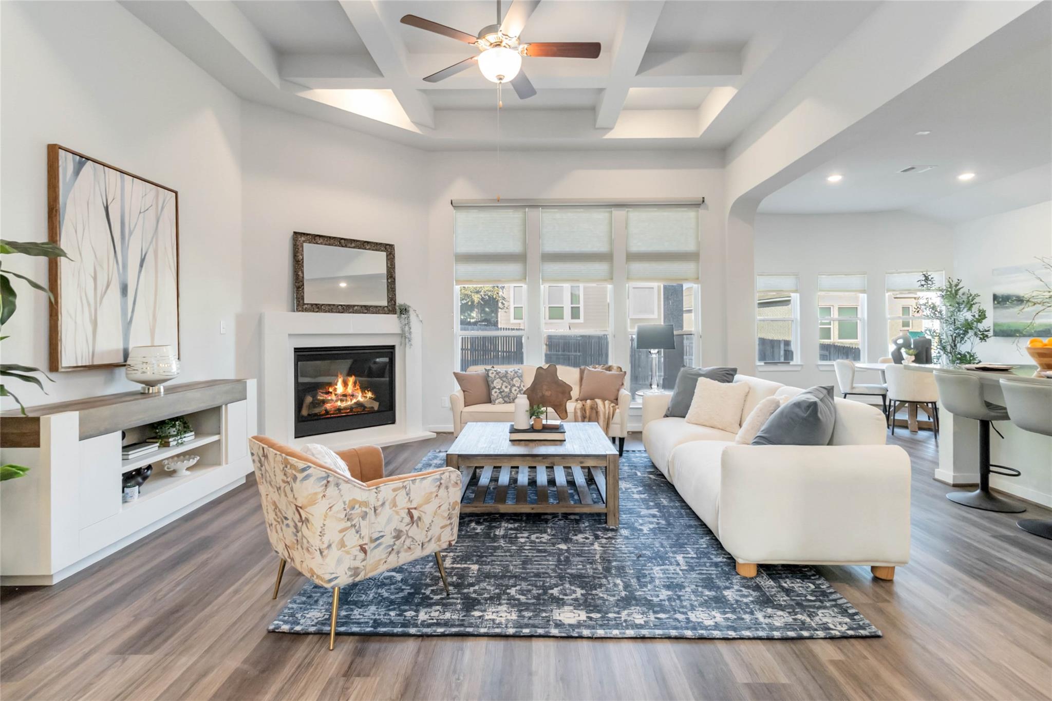 Living room with a glass covered fireplace, wood 