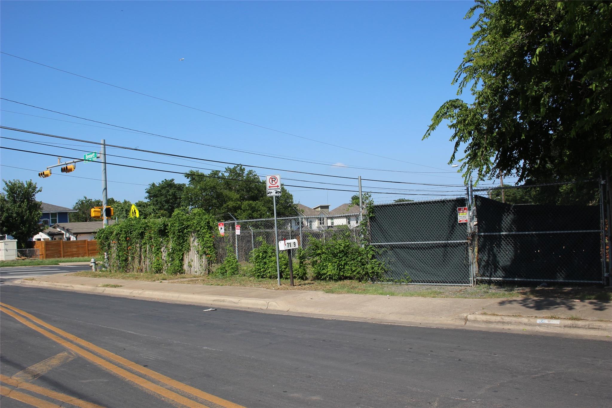 View of asphalt road featuring sidewalks, curbs, 