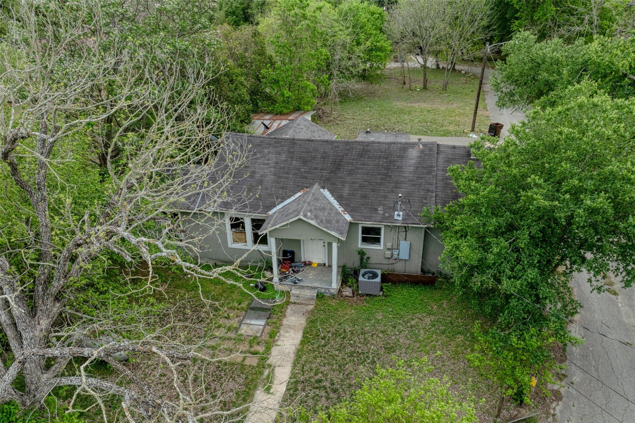 Aerial view showcasing the property's roof, surro