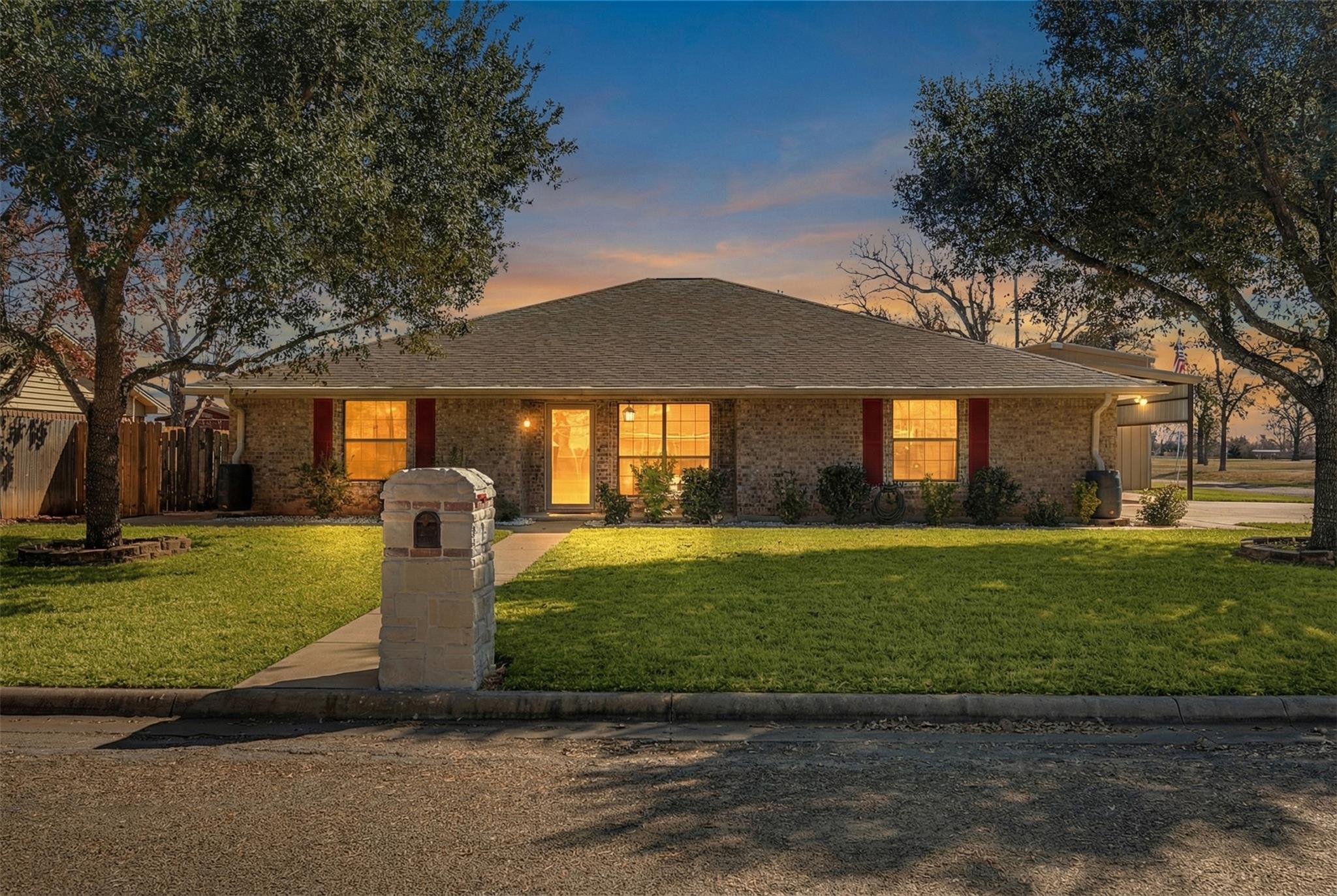 Ranch-style home with brick siding and roof with 